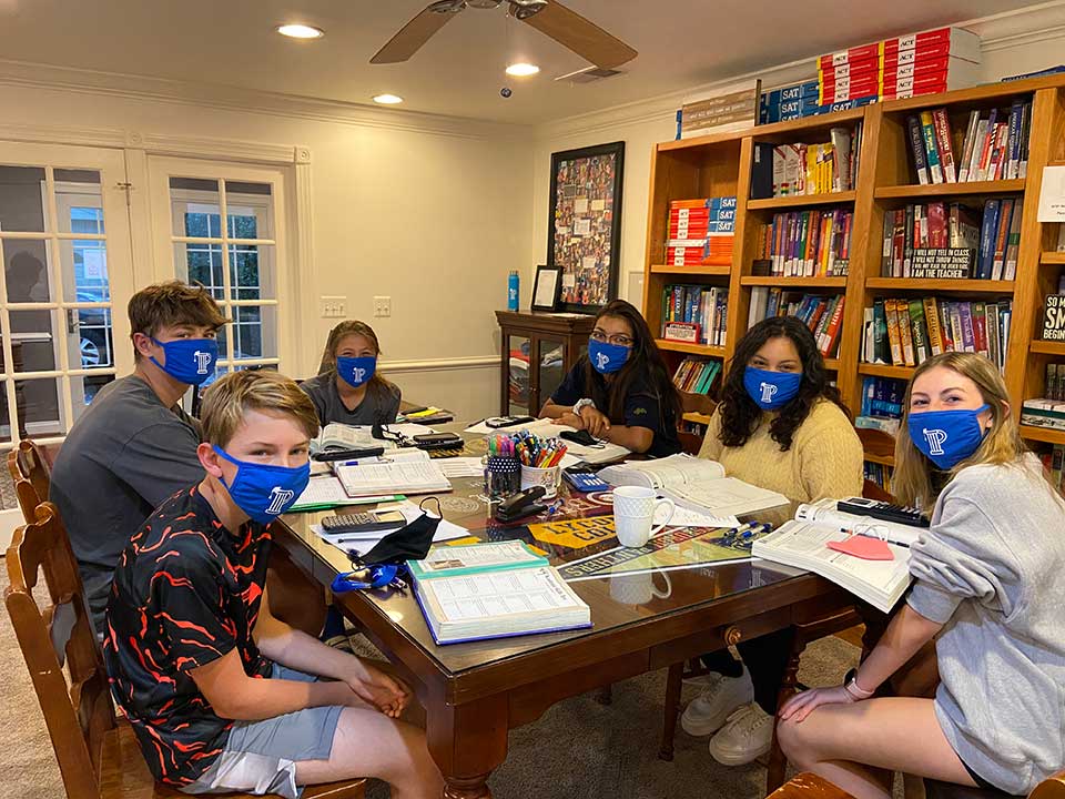 Julia Ross tutors a group of six high school students at the Professional Tutoring Cottage.